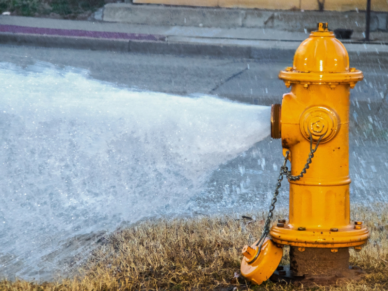 A gushing yellow fire hydrant